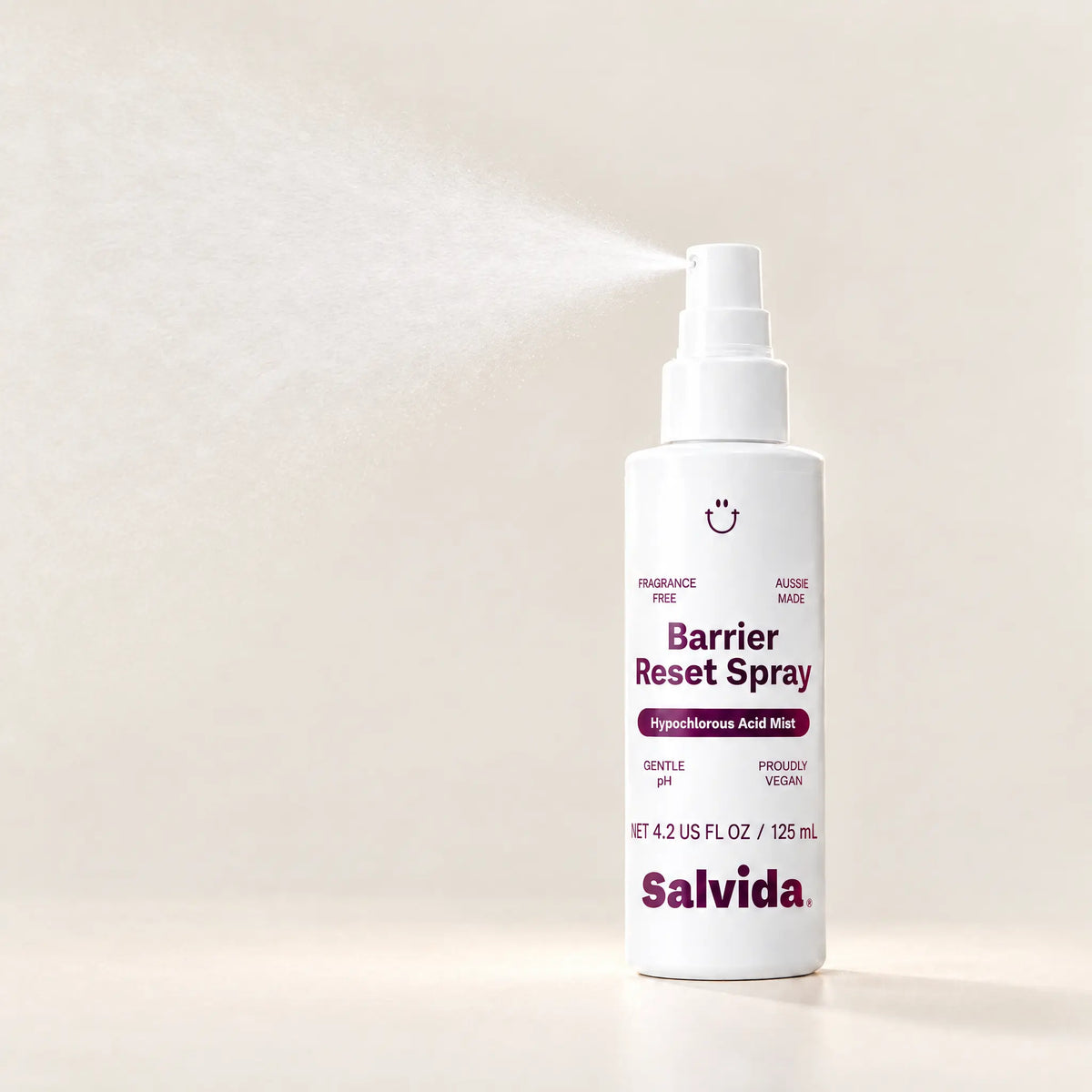 Salvida Barrier Reset Spray bottle shown mid-spray with a fine mist