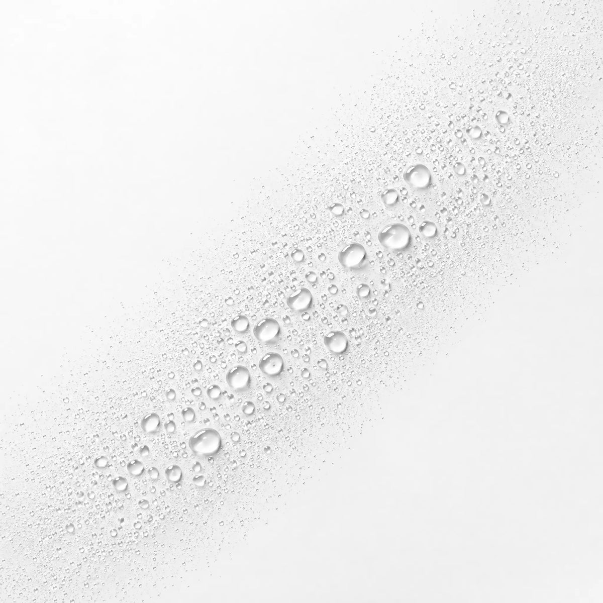 Close-up of water droplets on a white surface