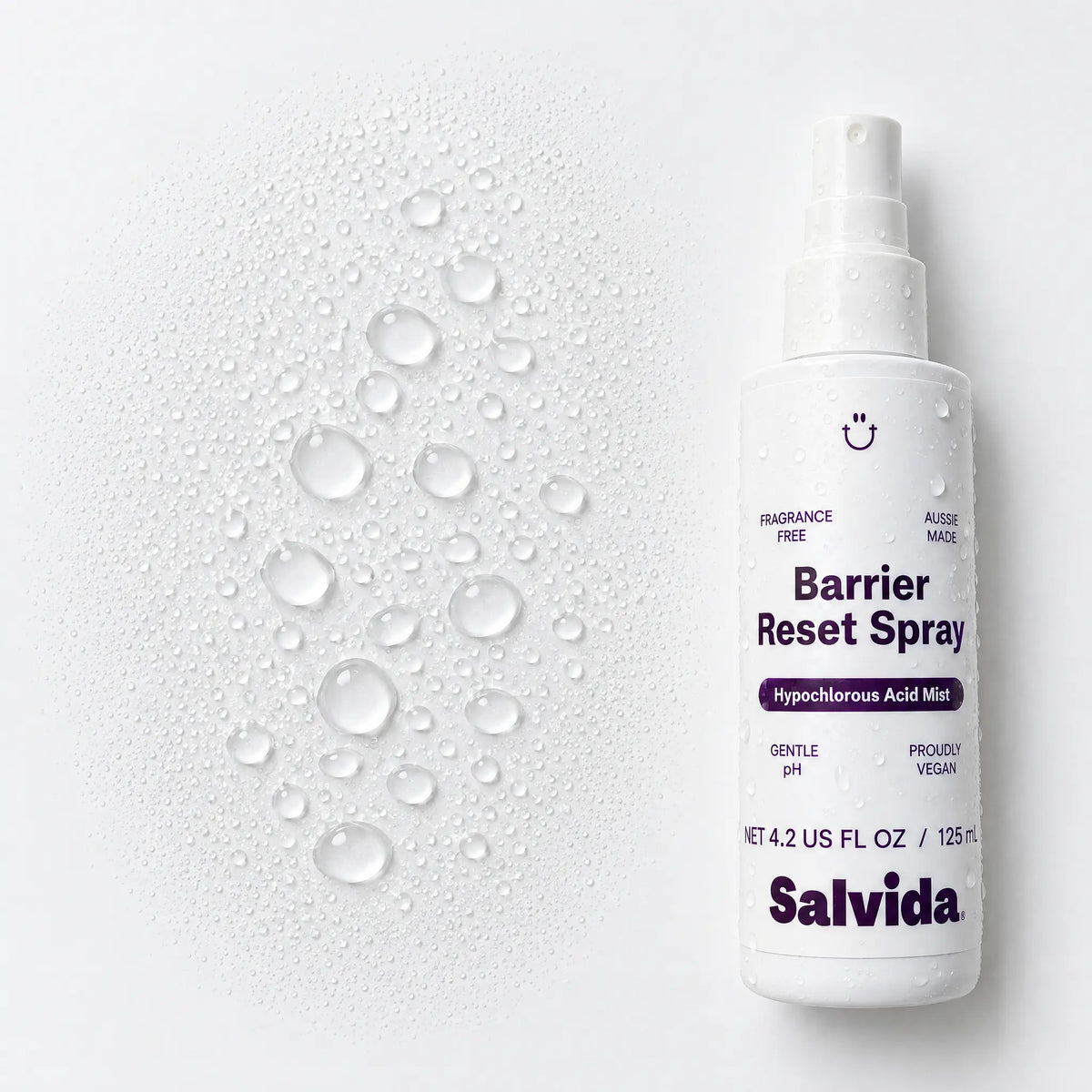 Salvida Barrier Reset Spray bottle beside a close-up of water droplets on a cream background